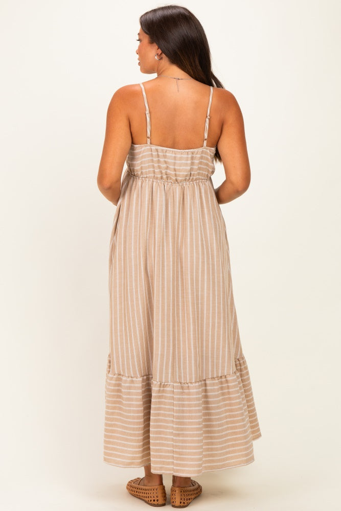 woman wearing a beige striped maternity maxi dress with a tiered hem and adjustable straps, showing her back