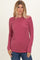 woman wearing a raspberry ribbed long sleeve top with a crew neckline paired with blue jeans