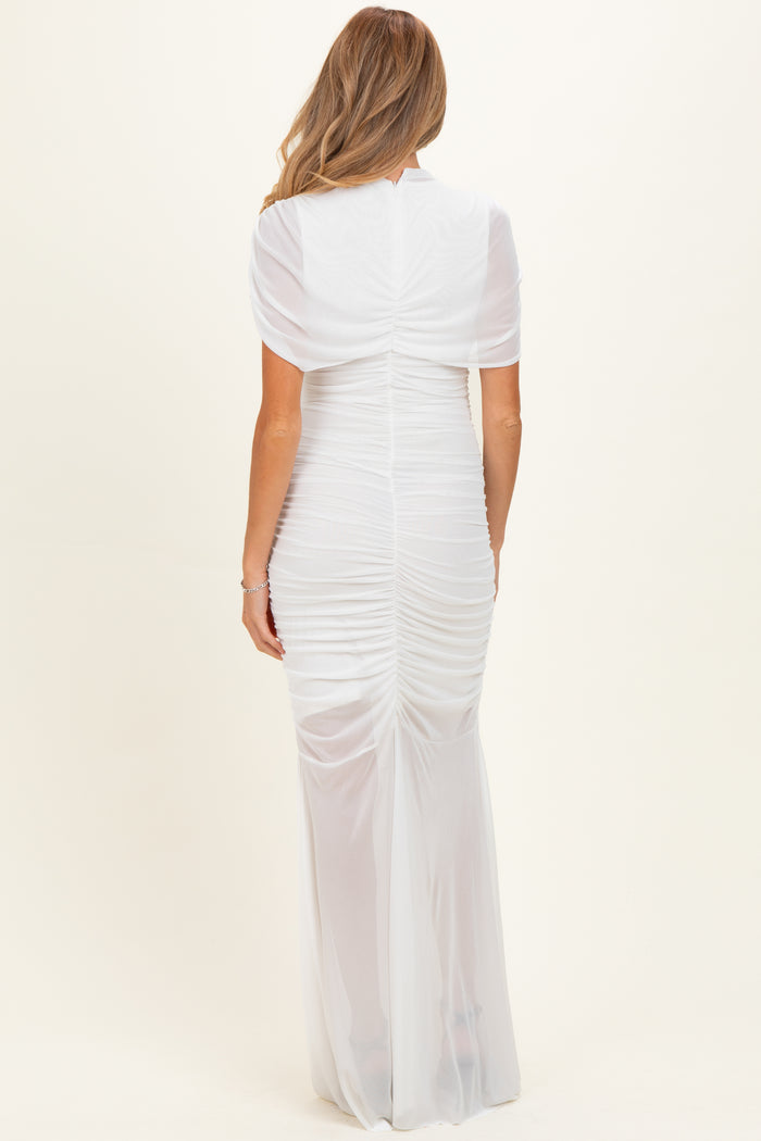 woman wearing a white maternity dress with back ruching and short sleeves, showing off a baby bump