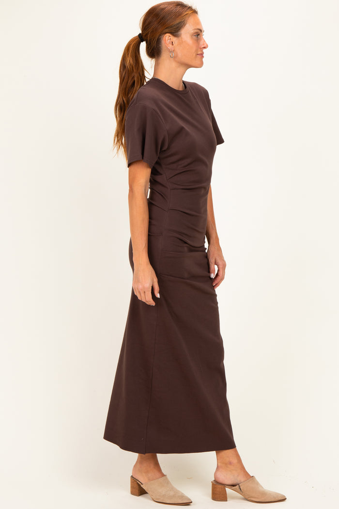 woman wearing a brown short sleeve ruched maxi dress and beige block heel mules