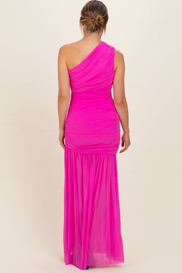 woman wearing a bright pink one-shoulder maternity gown with ruching and a flowing skirt