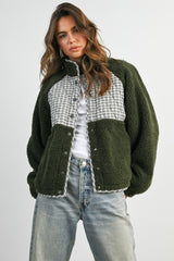 woman wearing an olive green and plaid check oversized button-up fleece jacket with dropped shoulders and a relaxed fit