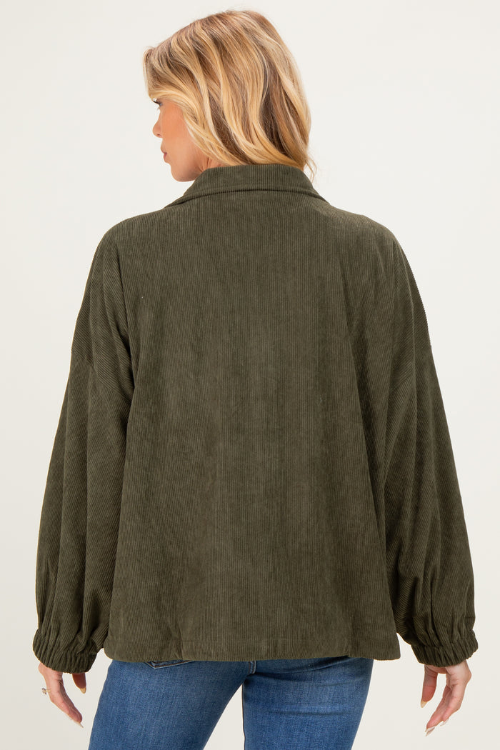woman wearing a green corduroy maternity jacket with oversized sleeves viewed from the back