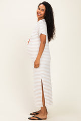 woman wearing a striped maternity maxi dress with side slits and a visible baby bump