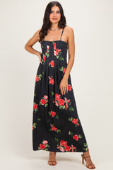 woman wearing a black floral maxi dress with red roses and spaghetti straps