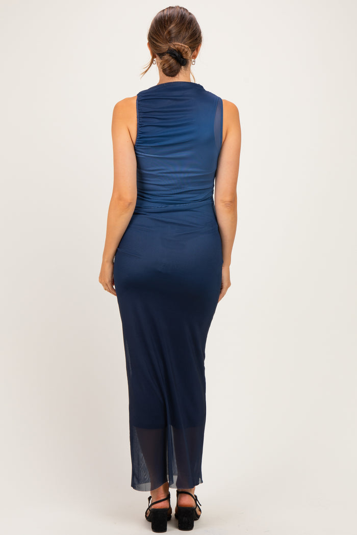 woman wearing a navy blue sleeveless maternity dress with a flowy silhouette, showing her baby bump from the back