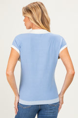 woman wearing a light blue short sleeve maternity top with white collar and ribbed hem, seen from the back