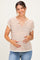 woman wearing a striped short sleeve maternity top and gently holding her baby bump