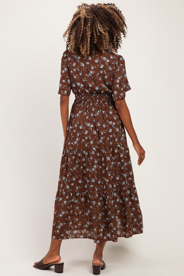 woman wearing a brown floral maternity dress with short sleeves and a cinched waist, seen from the back