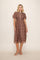 woman wearing a brown plaid midi dress with short puff sleeves and a button-down front