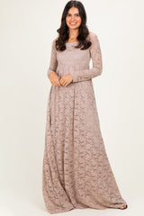 woman wearing a long sleeve taupe lace maxi dress with a flowy skirt
