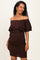 woman wearing a brown off-the-shoulder maternity dress with ruffle details and a visible baby bump