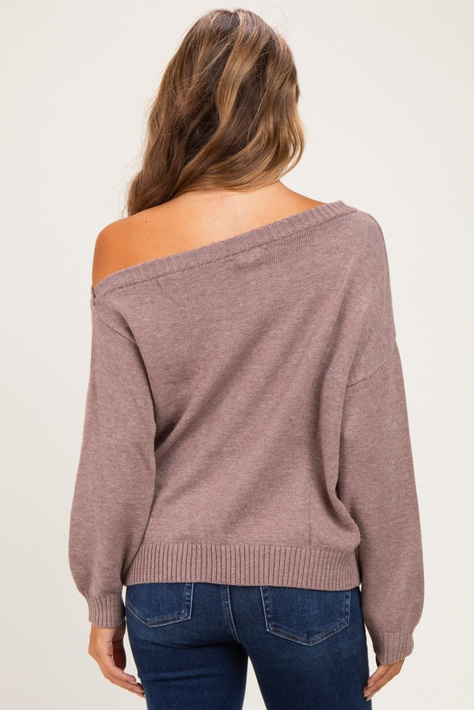 woman wearing a mauve off-the-shoulder maternity sweater with loose sleeves and a relaxed fit