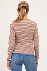 woman wearing a striped maternity long sleeve top with a fitted style, viewed from the back with blue jeans