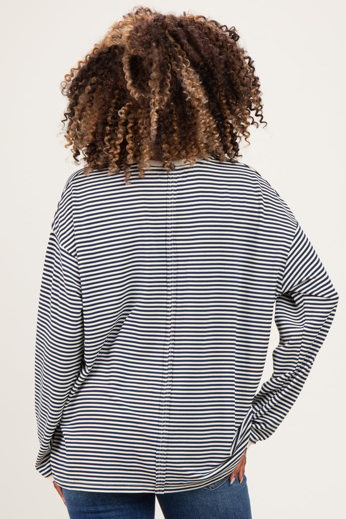 woman wearing a black and white striped maternity top, showing the back view with loose fit and wide sleeves