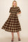 woman wearing a brown and beige plaid midi dress with short sleeves and a smocked bodice