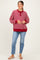 woman wearing a red and white striped maternity sweatshirt with a button front and relaxed fit, paired with light blue jeans