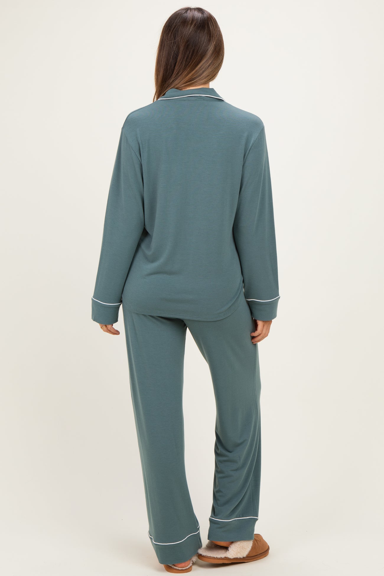 woman wearing a teal maternity pajama set with long sleeves and matching pants, viewed from the back