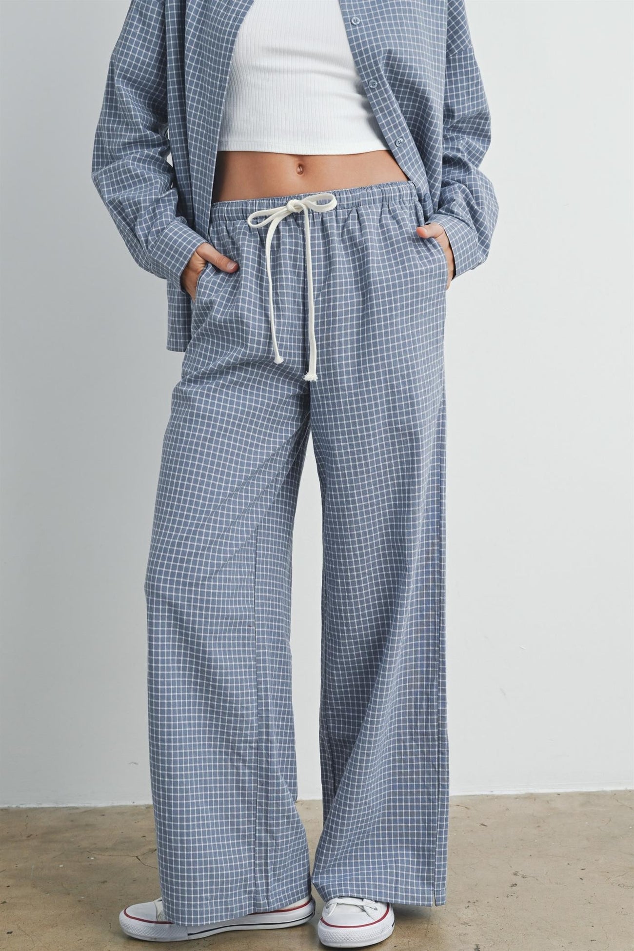 woman wearing blue and white checked wide-leg pants with drawstring waist and pockets