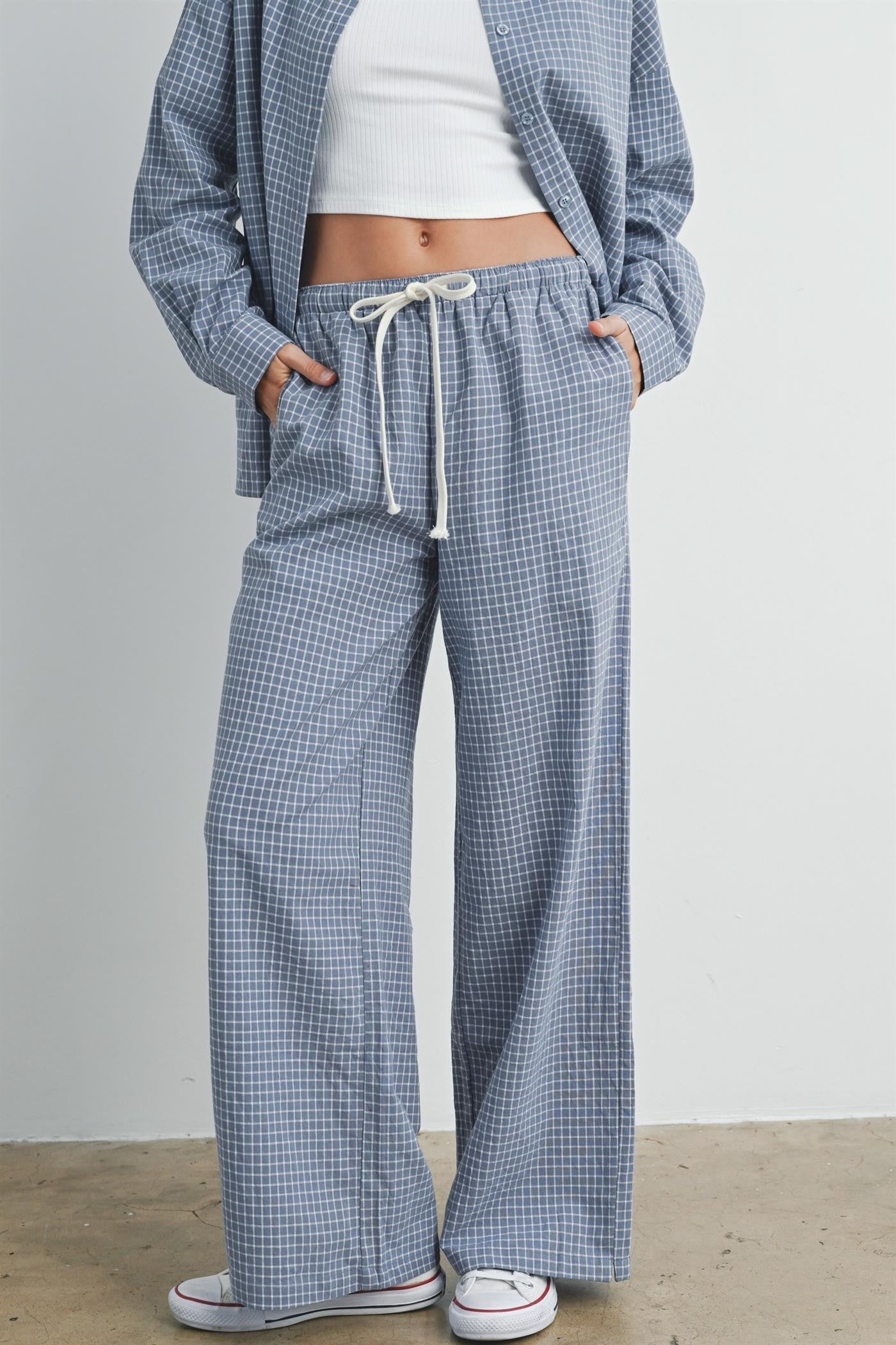 woman wearing blue and white checked wide-leg pants with drawstring waist and pockets