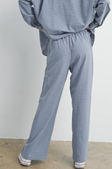 woman wearing blue and white checked loose-fitting pants with an elastic waistband from the back