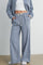 woman wearing blue and white checked wide-leg pants with drawstring waist and pockets