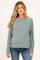 woman wearing a teal and white striped maternity top with long sleeves and relaxed fit