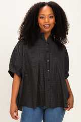 woman wearing a black and blue plaid short sleeve button-up shirt with a relaxed fit and a collar
