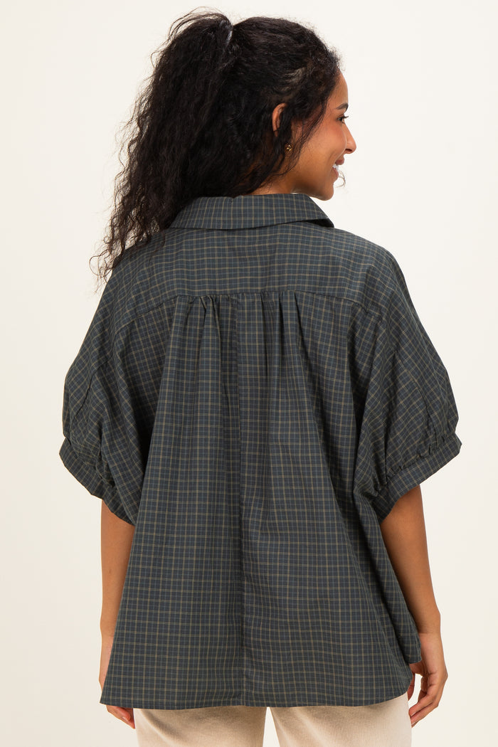 woman wearing a dark green checkered maternity shirt with puff sleeves and a relaxed fit, showing the back view