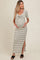 woman wearing a black and white striped maternity dress with a twist front and side slit, showing her baby bump