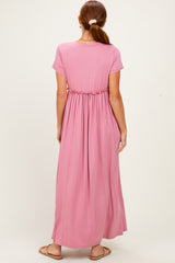 woman wearing a pink short sleeve maxi dress with an elastic waist from the back