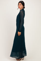 woman wearing a dark teal long sleeve lace maxi dress with a fitted bodice and flared skirt