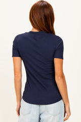 woman wearing a navy blue short sleeve fitted ribbed top viewed from the back