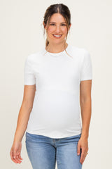 woman wearing a white short sleeve ribbed maternity top and showing her baby bump