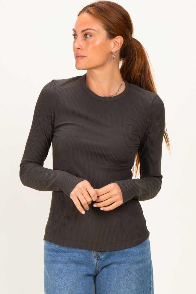 woman wearing a dark gray long sleeve ribbed top with a crew neckline and casual styling