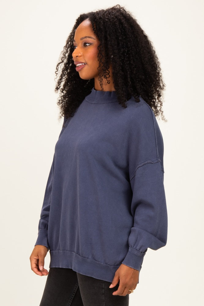 woman wearing a navy blue oversized sweatshirt with long sleeves and a relaxed fit