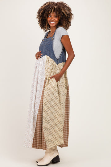 woman wearing a patchwork maternity maxi dress with denim top and multi-patterned skirt, showcasing her baby bump