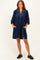 woman wearing a navy blue relaxed fit dress with a v-neckline and pockets