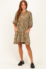 woman wearing a khaki paisley print short dress with puff sleeves and side pockets