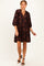 woman wearing a dark brown floral print short sleeve dress with a v-neckline and a loose fit
