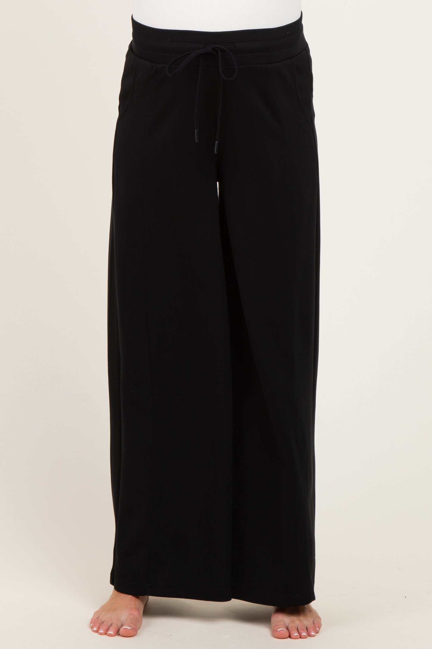 maternity wear black wide-leg pants with adjustable drawstring waist, model showing bare feet