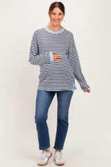 woman wearing a navy and white striped maternity top with long sleeves and a baby bump, paired with blue jeans