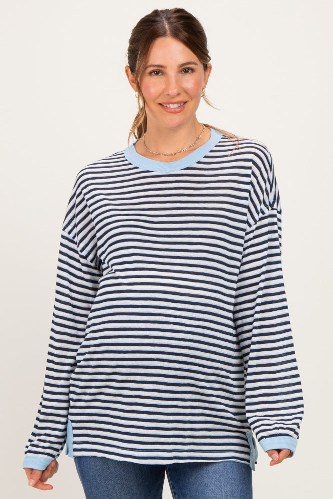 woman wearing a navy and light blue striped maternity top with long sleeves and side slits, featuring a relaxed fit