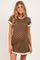 woman wearing a brown polka dot maternity dress with short sleeves and a scalloped hem, showcasing her baby bump