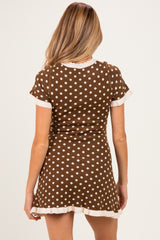 woman wearing a brown polka dot maternity dress with short sleeves and a flared hem, showing her back