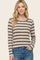woman wearing a cream and brown striped long sleeve top with a round neckline and casual fit