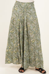 woman wearing a green floral patterned maxi skirt with an elastic waistband and flowing silhouette