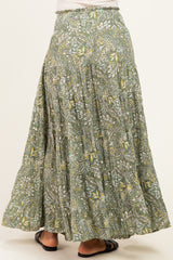 woman wearing a flowy green and yellow floral maxi skirt showing back view