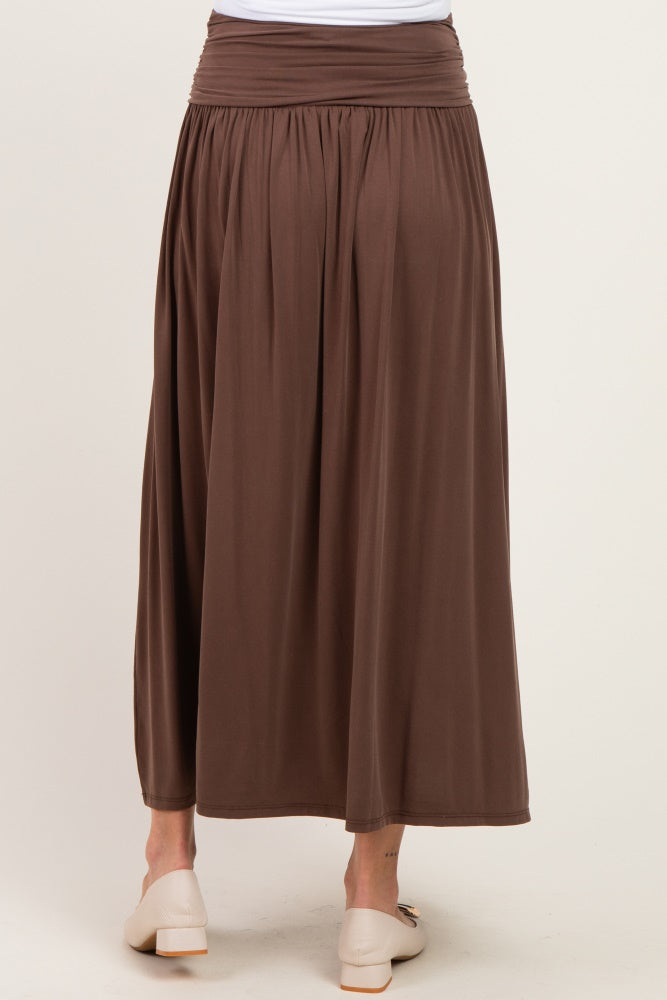 woman wearing a brown maternity maxi skirt with a comfortable smocked waistband and flowy silhouette