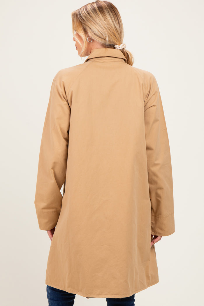woman wearing a tan maternity coat, viewed from the back